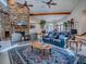 Cozy living room featuring a stone fireplace, comfortable seating, and a large area rug at 11226 Lane Park Rd, Tavares, FL 32778