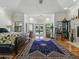 Large primary bedroom showcasing natural light, hardwood floors and access to the outdoor pool area at 11226 Lane Park Rd, Tavares, FL 32778