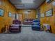 A media room with comfortable seating, wood paneling, projector screen, and a relaxed atmosphere at 11226 Lane Park Rd, Tavares, FL 32778