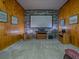 A media room with carpet, wood paneling, projector screen, and various decor items for enhanced viewing at 11226 Lane Park Rd, Tavares, FL 32778