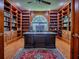 Spacious office featuring custom built-in shelving, hardwood floors, and a large window with lots of natural light at 11226 Lane Park Rd, Tavares, FL 32778