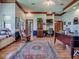 Another view of the spacious office featuring a window seat, built-in cabinets, and hardwood floors at 11226 Lane Park Rd, Tavares, FL 32778