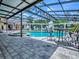 Enclosed pool and spa area with an outdoor dining space, ideal for enjoying meals by the water at 11226 Lane Park Rd, Tavares, FL 32778