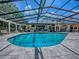 Enclosed pool with a hot tub, offering a serene space for relaxation and recreation at 11226 Lane Park Rd, Tavares, FL 32778
