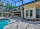 View of the sparkling pool and spa, seamlessly connecting to the home's elegant patio area at 11226 Lane Park Rd, Tavares, FL 32778