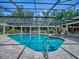 Enclosed sparkling pool features a spa and ample deck space, perfect for relaxation and entertainment at 11226 Lane Park Rd, Tavares, FL 32778