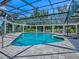 Enclosed pool with a spa and steel frame, offering a luxurious and private outdoor retreat at 11226 Lane Park Rd, Tavares, FL 32778