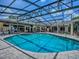 Relaxing screened-in pool and spa area with patio seating, perfect for outdoor enjoyment at 11226 Lane Park Rd, Tavares, FL 32778