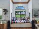 Inviting window seat with colorful pillows, offering a serene view of the outdoor landscape at 11226 Lane Park Rd, Tavares, FL 32778