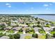 Aerial view of a residential community surrounded by lush greenery and a large lake, offering picturesque waterfront living at 1123 Barnacle Ter, The Villages, FL 32162