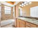 Bathroom featuring a tub/shower combo and a vanity with granite countertops for a luxurious feel at 1123 Barnacle Ter, The Villages, FL 32162
