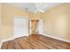 Spacious bedroom with wood floors, double closets, and an open doorway, providing ample storage at 1123 Barnacle Ter, The Villages, FL 32162