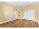 Bedroom with wood floors, double closets, and an open doorway, providing ample storage and light at 1123 Barnacle Ter, The Villages, FL 32162