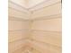 Walk-in closet with built-in wire shelving, offering ample storage space for organization at 1123 Barnacle Ter, The Villages, FL 32162