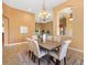 Elegant dining room with a chandelier, decorative rug, and comfortable seating for formal occasions at 1123 Barnacle Ter, The Villages, FL 32162