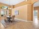 Elegant dining room boasting a modern chandelier, wainscotting, and a view into another room at 1123 Barnacle Ter, The Villages, FL 32162