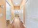 Hallway leading to bathroom with walk-in closet and several storage options at 1123 Barnacle Ter, The Villages, FL 32162