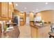 Well-equipped kitchen with granite countertops, stainless steel appliances, and eat-in bar area at 1123 Barnacle Ter, The Villages, FL 32162