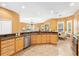 Open-concept kitchen with granite countertops, ample cabinet space, and a view of the breakfast nook at 1123 Barnacle Ter, The Villages, FL 32162