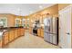 Spacious kitchen featuring stainless steel appliances, granite countertops, and ample cabinet space at 1123 Barnacle Ter, The Villages, FL 32162