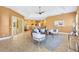This living room features tile flooring, stylish furniture, and provides access to the kitchen area at 1123 Barnacle Ter, The Villages, FL 32162