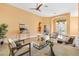 Inviting living room featuring tile floors, comfortable seating, and an open layout perfect for entertaining at 1123 Barnacle Ter, The Villages, FL 32162
