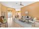 Open-concept living area showcasing tile flooring, elegant furnishings, and a view into the dining space at 1123 Barnacle Ter, The Villages, FL 32162