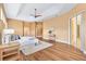 This bright and spacious main bedroom boasts wood floors, tray ceilings, an ensuite bath, and private outdoor access at 1123 Barnacle Ter, The Villages, FL 32162