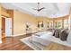 This beautiful main bedroom includes wood floors, tray ceilings, an ensuite bath, and private outdoor access at 1123 Barnacle Ter, The Villages, FL 32162