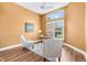 Well-lit office space with wood floors, bright windows, and modern furnishings, creating an inviting workspace at 1123 Barnacle Ter, The Villages, FL 32162