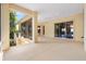 Covered lanai providing a transition from the home to the backyard, featuring screened openings and sliding glass doors at 1123 Barnacle Ter, The Villages, FL 32162
