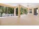 Spacious screened-in lanai with a ceiling fan, offering a serene outdoor living space with views of lush greenery at 1123 Barnacle Ter, The Villages, FL 32162