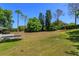 Expansive backyard featuring a trampoline and ample space for outdoor activities surrounded by mature trees and lush greenery at 11442 Beggs Ct, Clermont, FL 34711