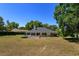 Large backyard with trampoline, white picket fence, and mature trees at 11442 Beggs Ct, Clermont, FL 34711
