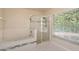 Bathroom featuring a soaking tub, glass enclosed shower, and a large window at 11442 Beggs Ct, Clermont, FL 34711