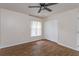 Serene bedroom with wood floors, large closet, and a ceiling fan at 11442 Beggs Ct, Clermont, FL 34711