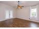 Bright bedroom with wood flooring, double doors to the outside, and large window at 11442 Beggs Ct, Clermont, FL 34711
