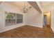 Open-concept dining room featuring hardwood floors and large windows at 11442 Beggs Ct, Clermont, FL 34711
