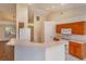 Bright kitchen with ample counter space, white appliances, and adjacent living area at 11442 Beggs Ct, Clermont, FL 34711