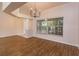 Spacious living room featuring wood floors, large windows, and modern chandelier at 11442 Beggs Ct, Clermont, FL 34711