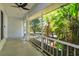 Inviting screened-in porch with ceiling fan and view of lush greenery at 11442 Beggs Ct, Clermont, FL 34711