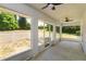 Screened porch overlooking a large yard with white picket fence and mature trees at 11442 Beggs Ct, Clermont, FL 34711