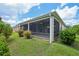 Beautiful screened-in patio with lush landscaping in the backyard at 1304 Zombar Pl, The Villages, FL 32163