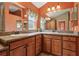Dual vanity bathroom with framed mirrors, granite countertops and custom cabinetry at 1304 Zombar Pl, The Villages, FL 32163