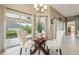 Charming dining area featuring a glass table and backyard views with ample natural light at 1304 Zombar Pl, The Villages, FL 32163