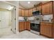 Updated kitchen featuring stainless steel appliances, granite countertops, and custom cabinetry at 1304 Zombar Pl, The Villages, FL 32163