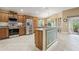 Spacious kitchen features stainless steel appliances, granite countertops, and ample cabinet space at 1304 Zombar Pl, The Villages, FL 32163
