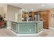 Open kitchen design features a large island, stainless steel appliances, and wooden cabinets at 1304 Zombar Pl, The Villages, FL 32163