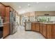 Well-lit kitchen area features stainless steel appliances, granite countertops, and abundant cabinetry at 1304 Zombar Pl, The Villages, FL 32163