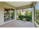 Relaxing screened-in lanai with a view of the landscaped yard at 1304 Zombar Pl, The Villages, FL 32163